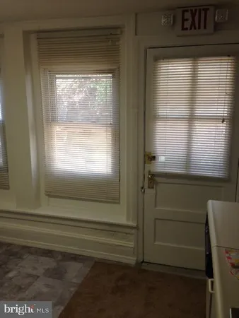 a bathroom with a window and a shower