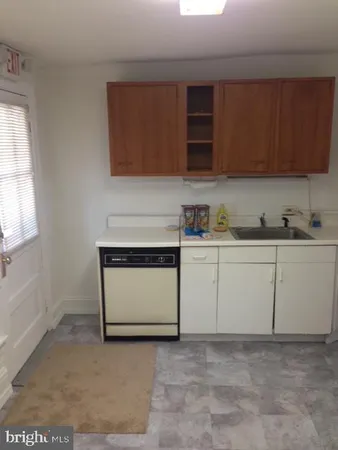 a view of a kitchen with white cabinets