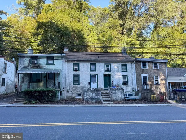 a front view of house with yard outdoor seating and garage