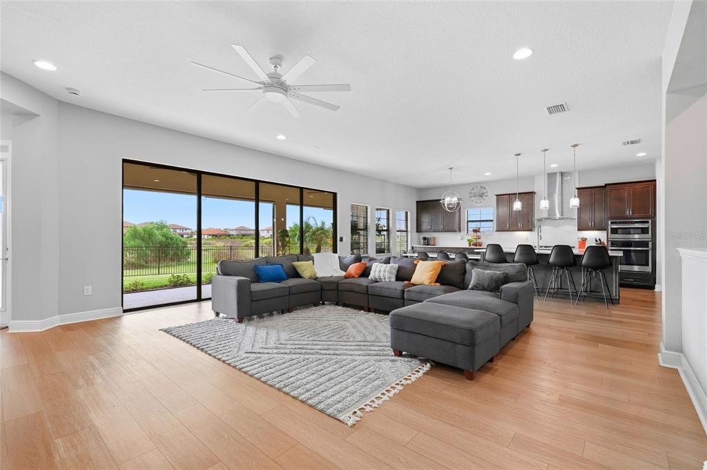 8207 Rushton Place Parrish, FL 34219 - Photo 13 of 65 a living room with furniture and a large window with kitchen view