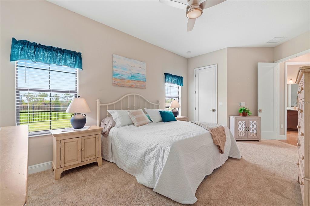 8207 Rushton Place Parrish, FL 34219 - Photo 20 of 65 a bedroom with a bed a table and chair