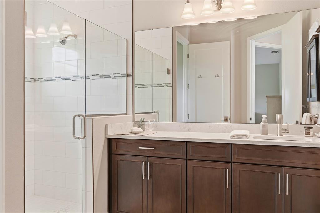 8207 Rushton Place Parrish, FL 34219 - Photo 21 of 65 a bathroom with a double vanity sink mirror and double