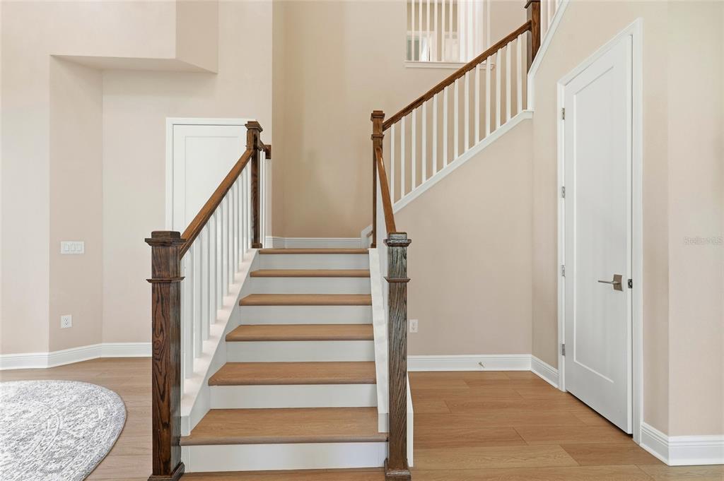 8207 Rushton Place Parrish, FL 34219 - Photo 28 of 65 a view of staircase with wooden floor and a rug