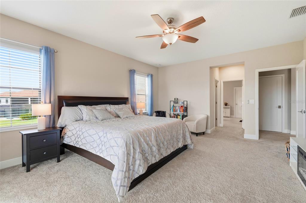 8207 Rushton Place Parrish, FL 34219 - Photo 36 of 65 a bedroom with a bed and a chandelier