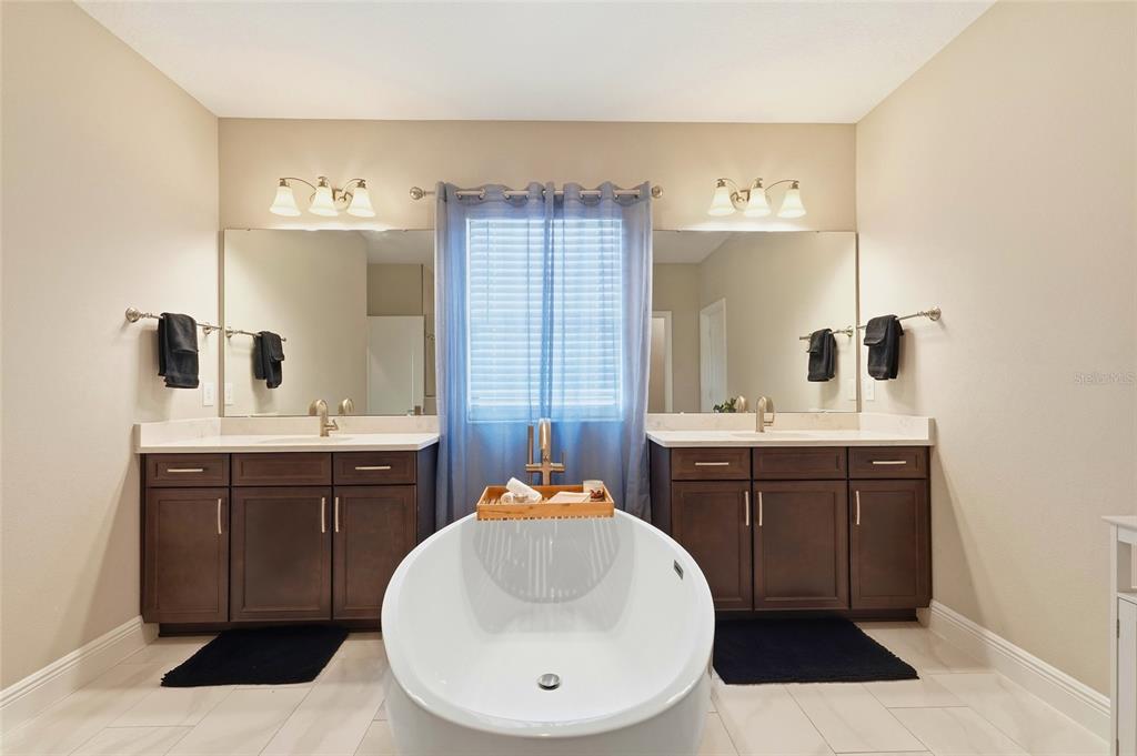 8207 Rushton Place Parrish, FL 34219 - Photo 38 of 65 a bathroom with a sink a toilet and mirror