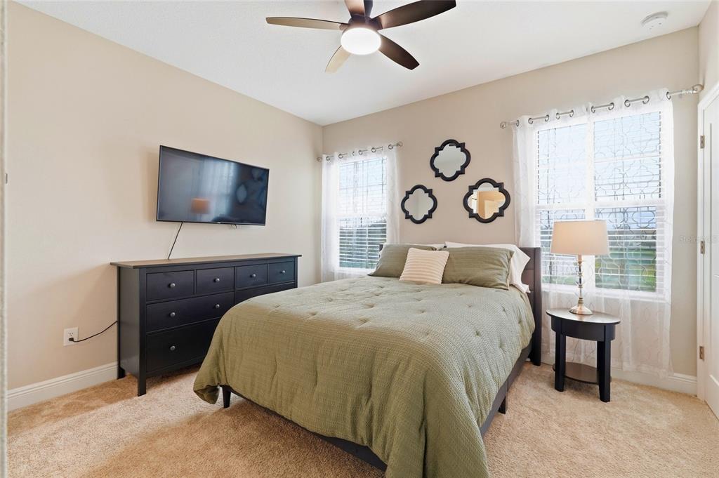 8207 Rushton Place Parrish, FL 34219 - Photo 40 of 65 a bedroom with a bed and a chandelier