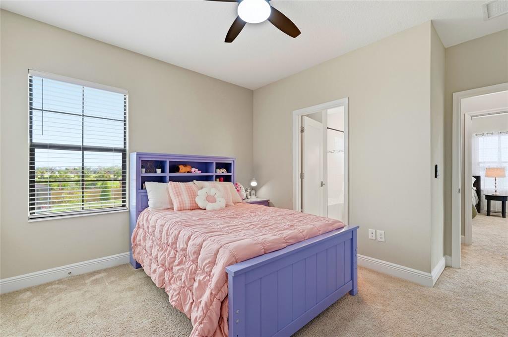 8207 Rushton Place Parrish, FL 34219 - Photo 45 of 65 a bedroom with a large bed and a chandelier fan