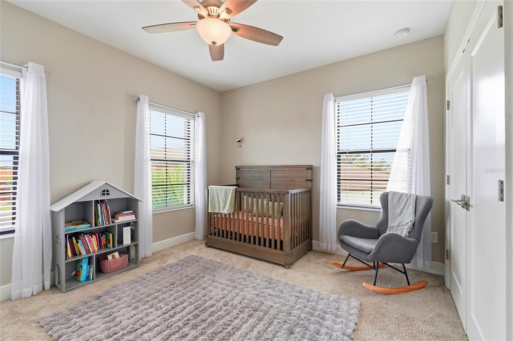 8207 Rushton Place Parrish, FL 34219 - Photo 46 of 65 a bedroom with furniture and a book shelf