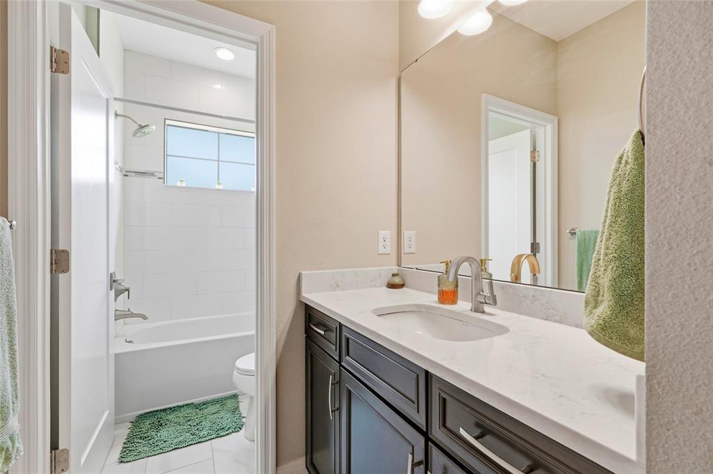 8207 Rushton Place Parrish, FL 34219 - Photo 49 of 65 a bathroom with a sink a toilet and shower