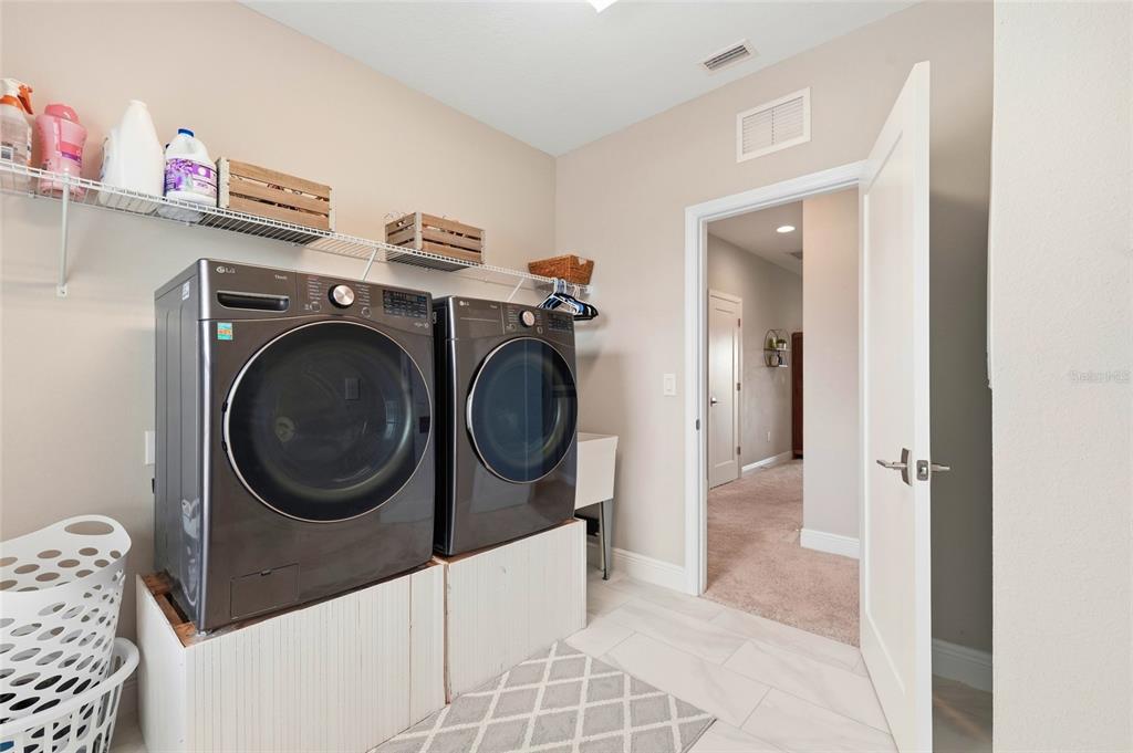 8207 Rushton Place Parrish, FL 34219 - Photo 51 of 65 a view of a storage & utility room with a washer dryer