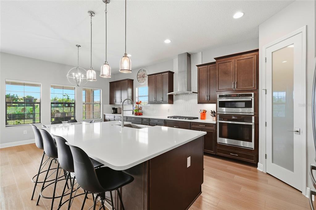 8207 Rushton Place Parrish, FL 34219 - Photo 9 of 65 a large kitchen with kitchen island a large island in the center