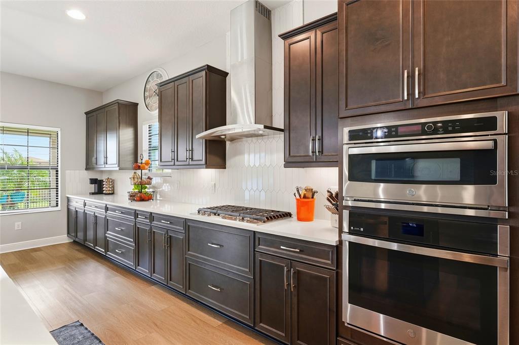 8207 Rushton Place Parrish, FL 34219 - Photo 10 of 65 a kitchen with stainless steel appliances granite countertop a stove microwave and sink