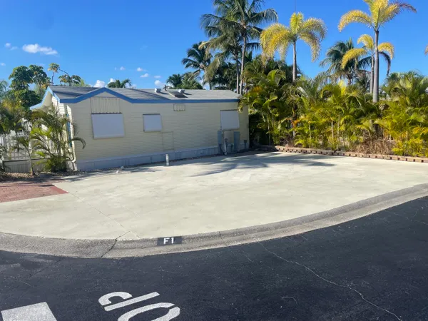 a view of a house with a yard and a garage