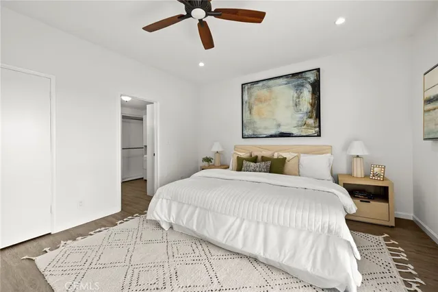 a bedroom with a large bed and a chandelier