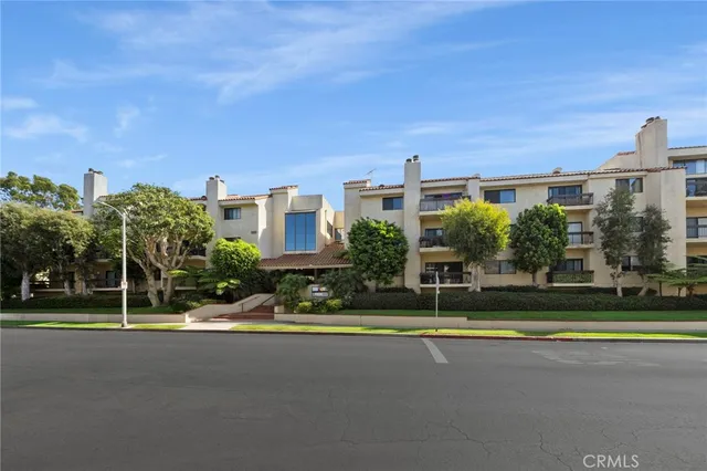 a view of a big building with a big yard and plants