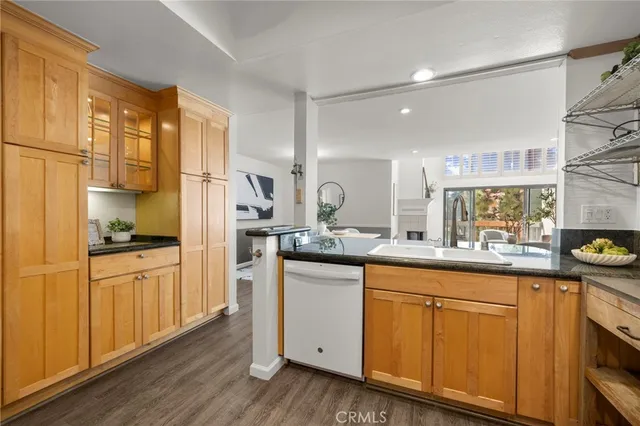 a kitchen with stainless steel appliances granite countertop a sink and cabinets