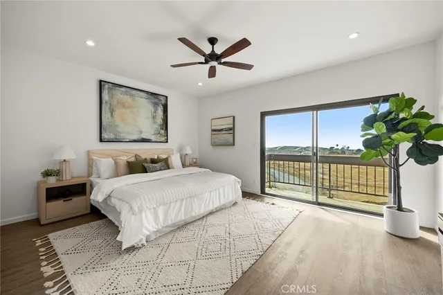 a spacious bedroom with a large bed and a chandelier
