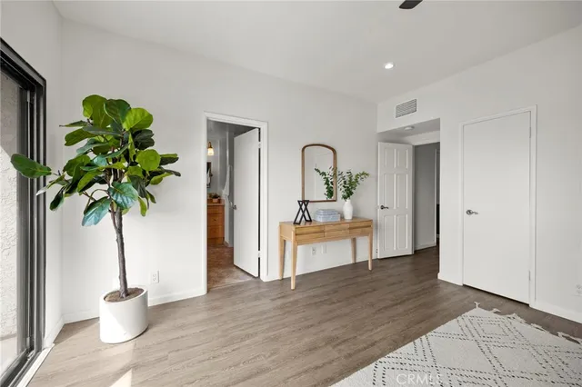 a living room with furniture and a potted plant
