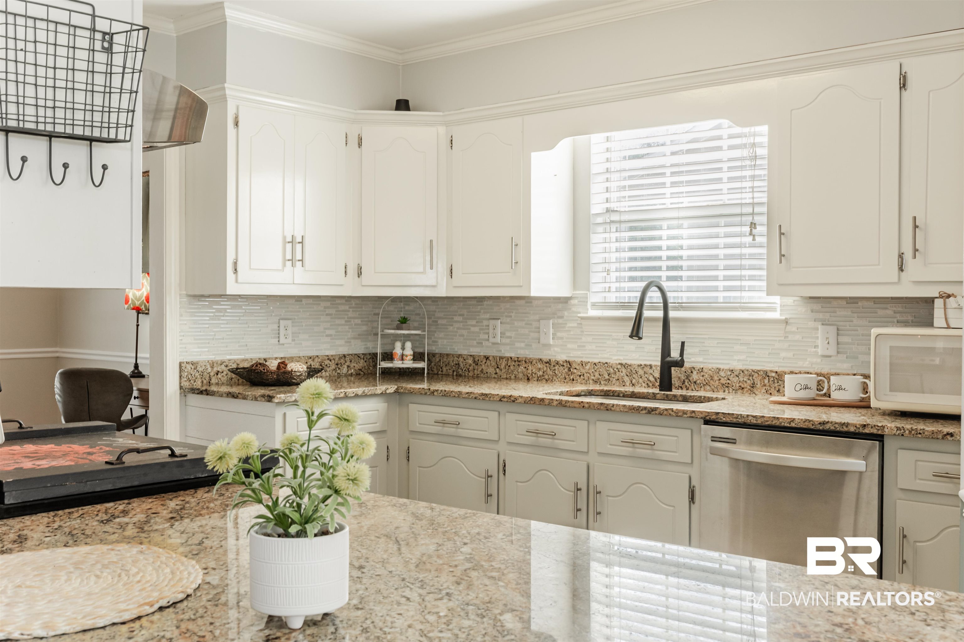3844 Isabel Way South Mobile, AL 36693 - Photo 9 of 49 Kitchen featuring ornamental molding, sink, stainless steel dishwasher, and white cabinets