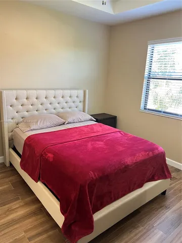 a bedroom with a bed and a ceiling fan