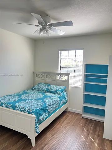 a white toilet sitting next to a shower