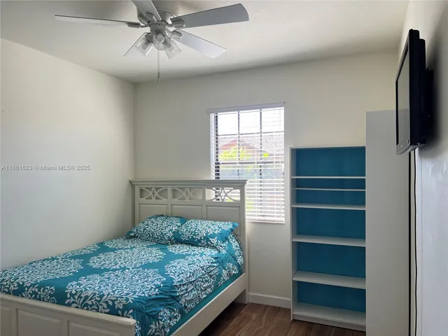 a living room with a wooden floor and a flat screen tv
