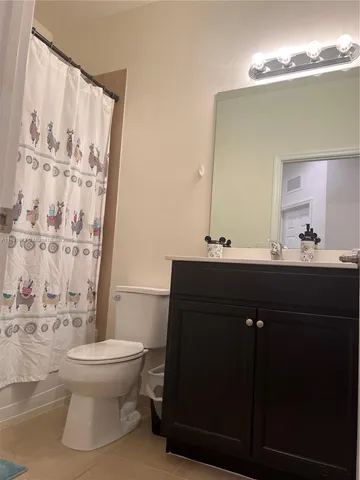 a view of a backyard with potted plants and wooden fence