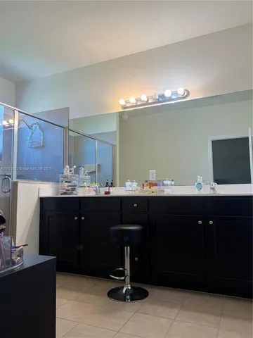 a living room with furniture a flat screen tv and a floor to ceiling window