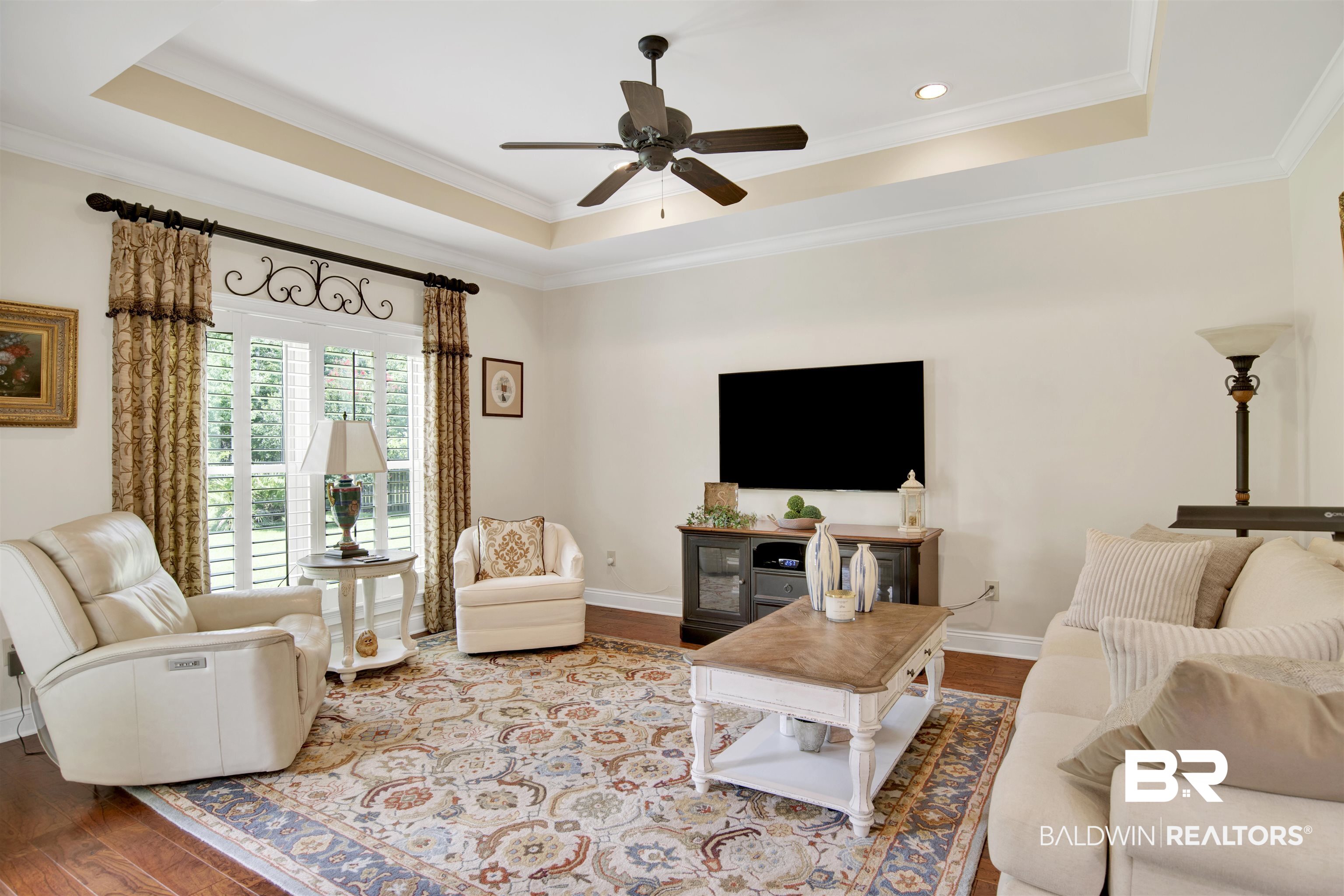 8358 Forest Lane Foley, AL 36535 - Photo 30 of 46 Living room with a tray ceiling, wood finished floors, ceiling fan, crown molding, and recessed lighting