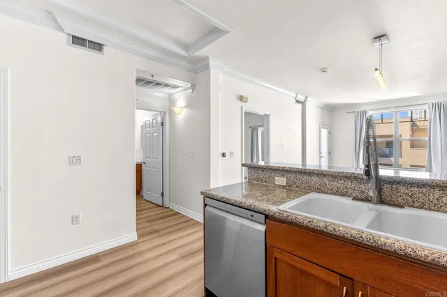 a living room with furniture a chandelier and a flat screen tv