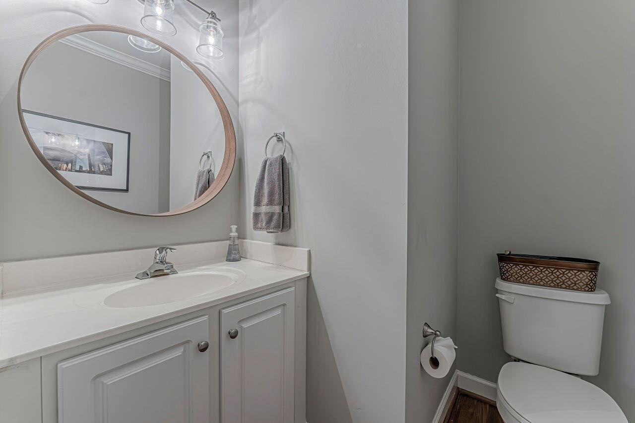 106 Hatfield Lane Raleigh, NC 27603 - Photo 14 of 29 a bathroom with a toilet a sink and mirror