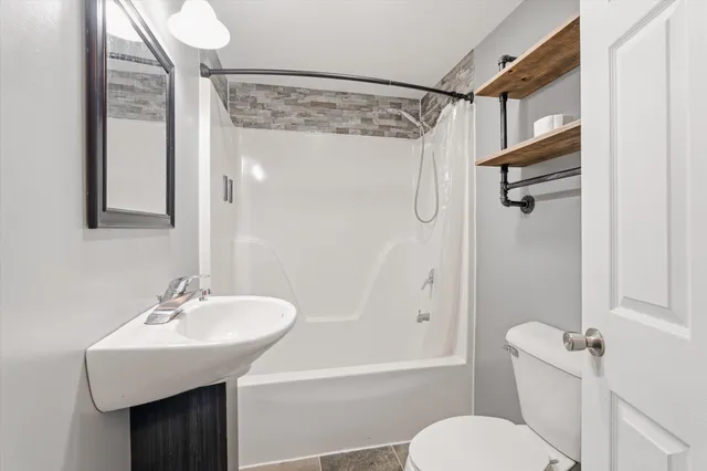 a view of a room with wooden floor and windows