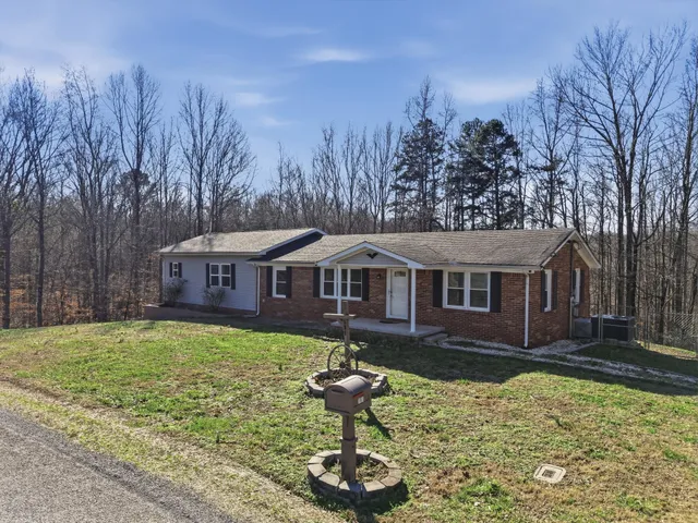 a house that has a tree in front of it