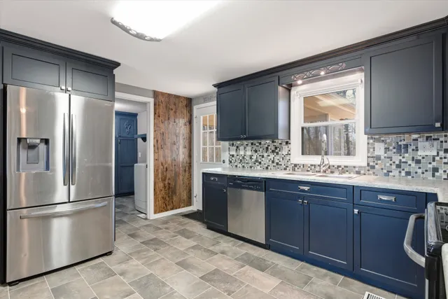 a kitchen with stainless steel appliances granite countertop a sink stove and microwave