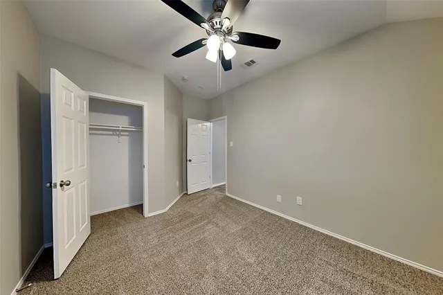 a bathroom with a granite countertop sink a large mirror and a toilet