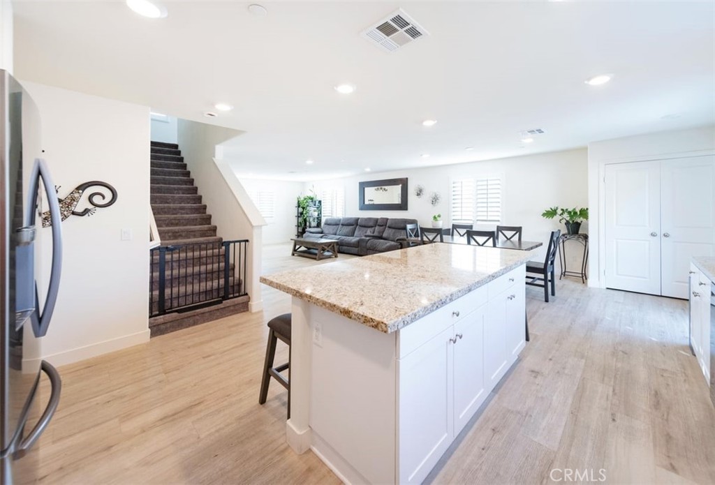 32078 Rambling Court Winchester, CA 92596 - Photo 19 of 48 a large kitchen with stainless steel appliances a large counter top a stove and a wooden floors