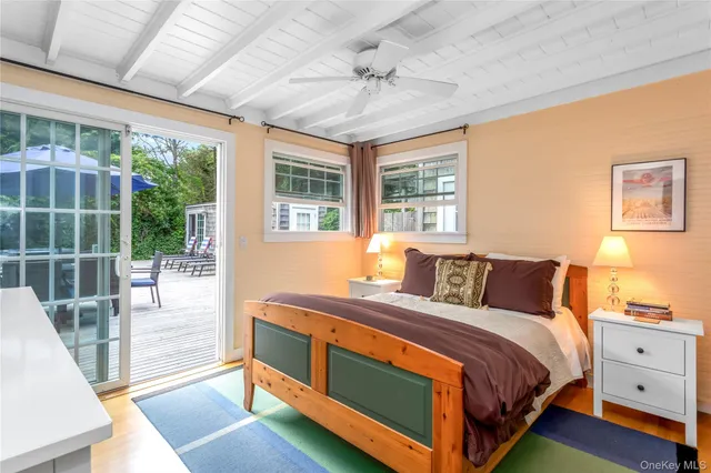 a bedroom with a bed and a large window with balcony view