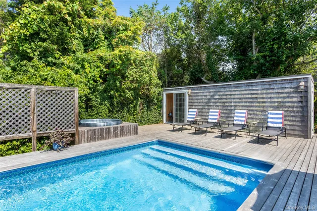 a view of backyard with deck and outdoor seating