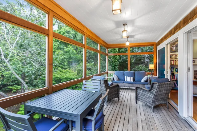 a living room with large windows and wooden floor
