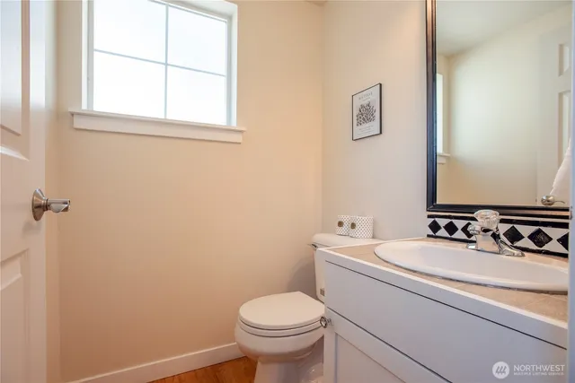 a bathroom with a sink toilet and a mirror