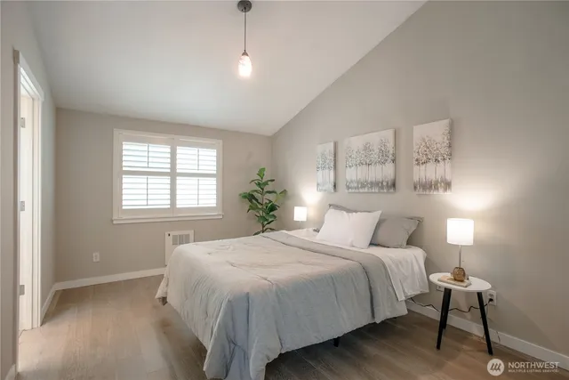 a bedroom with a large bed and a chandelier
