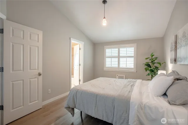 a bedroom with a bed and a lamp