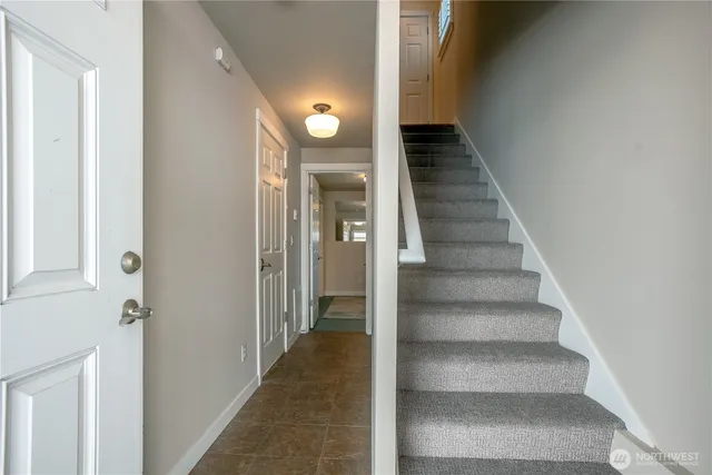 a view of a room with a table and chairs