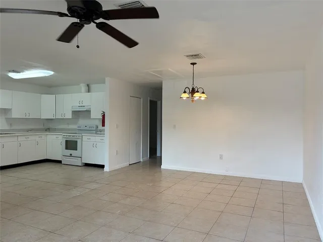 a view of a kitchen with a sink and dishwasher cabinets