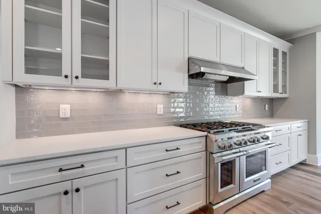 a view of a kitchen with a sink and wooden floor