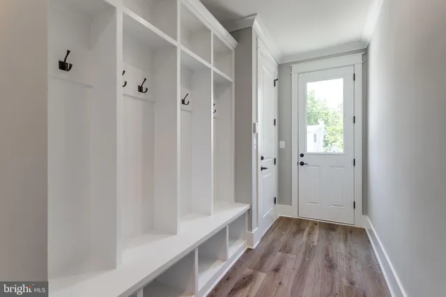 a view of staircase with lots of frames on wall and windows