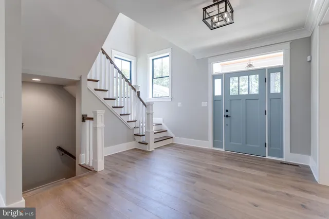 a view of entryway and hall with wooden floor