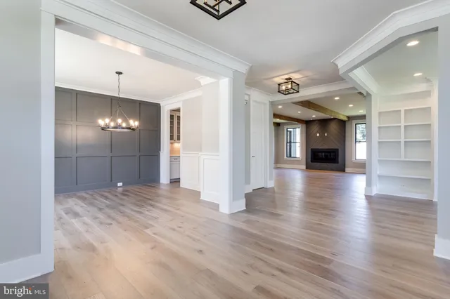 a view of wooden floor chandelier and window in a room