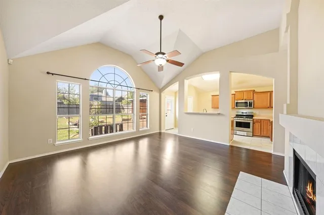 a view of a big room with wooden floor a chandelier