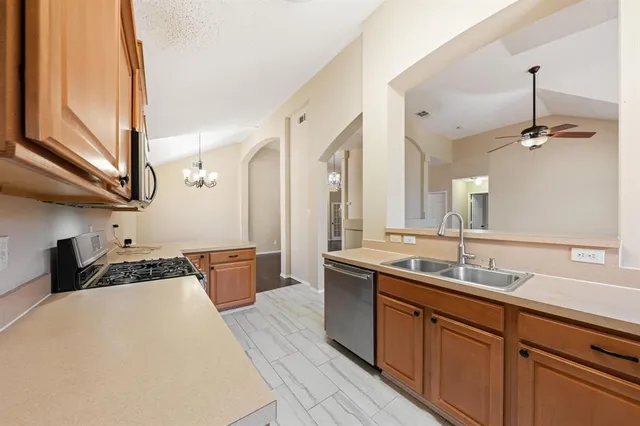 a kitchen with a sink stove and cabinets
